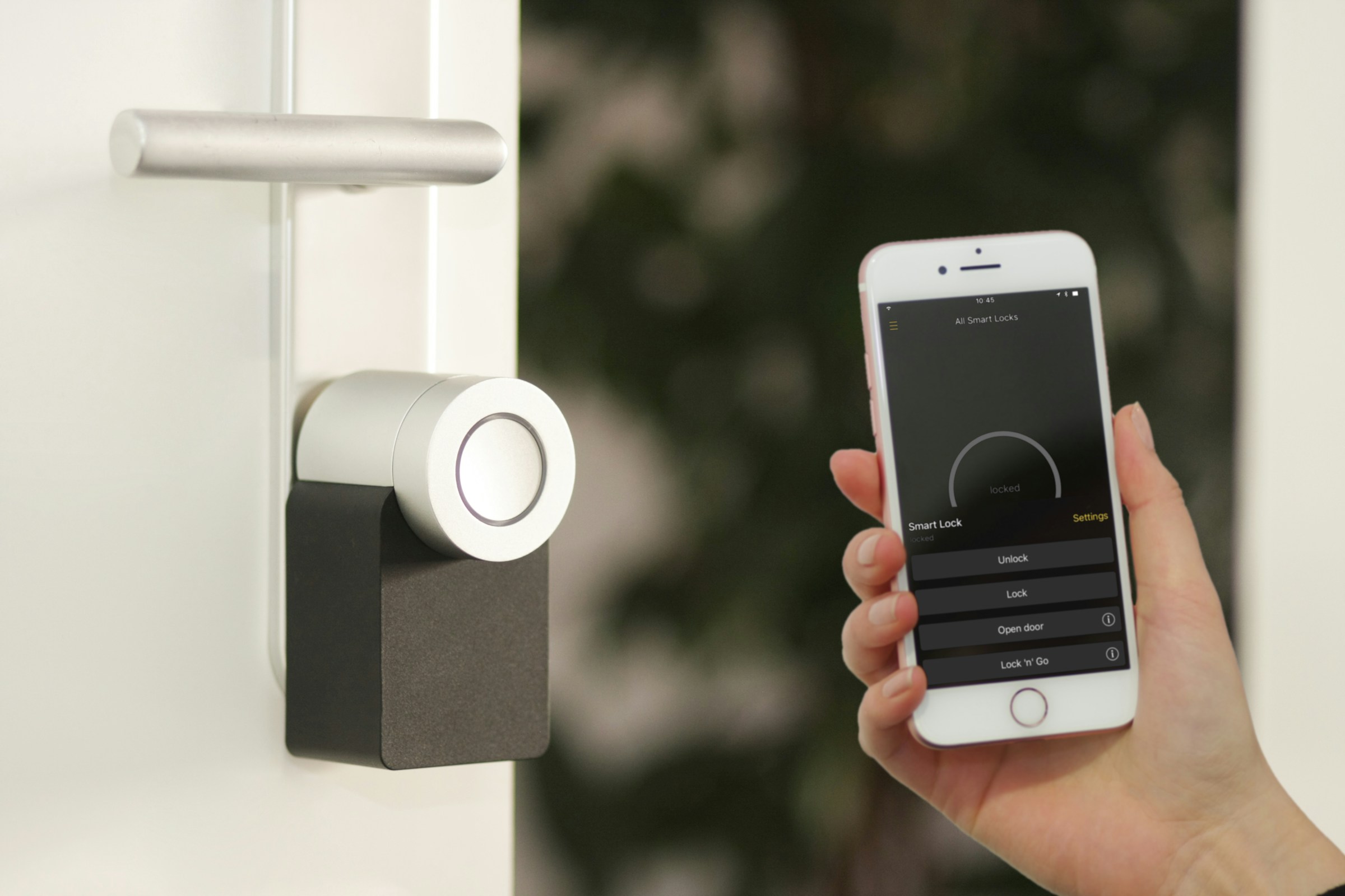 Installed Nuki smart door lock shown with a smartphone control app